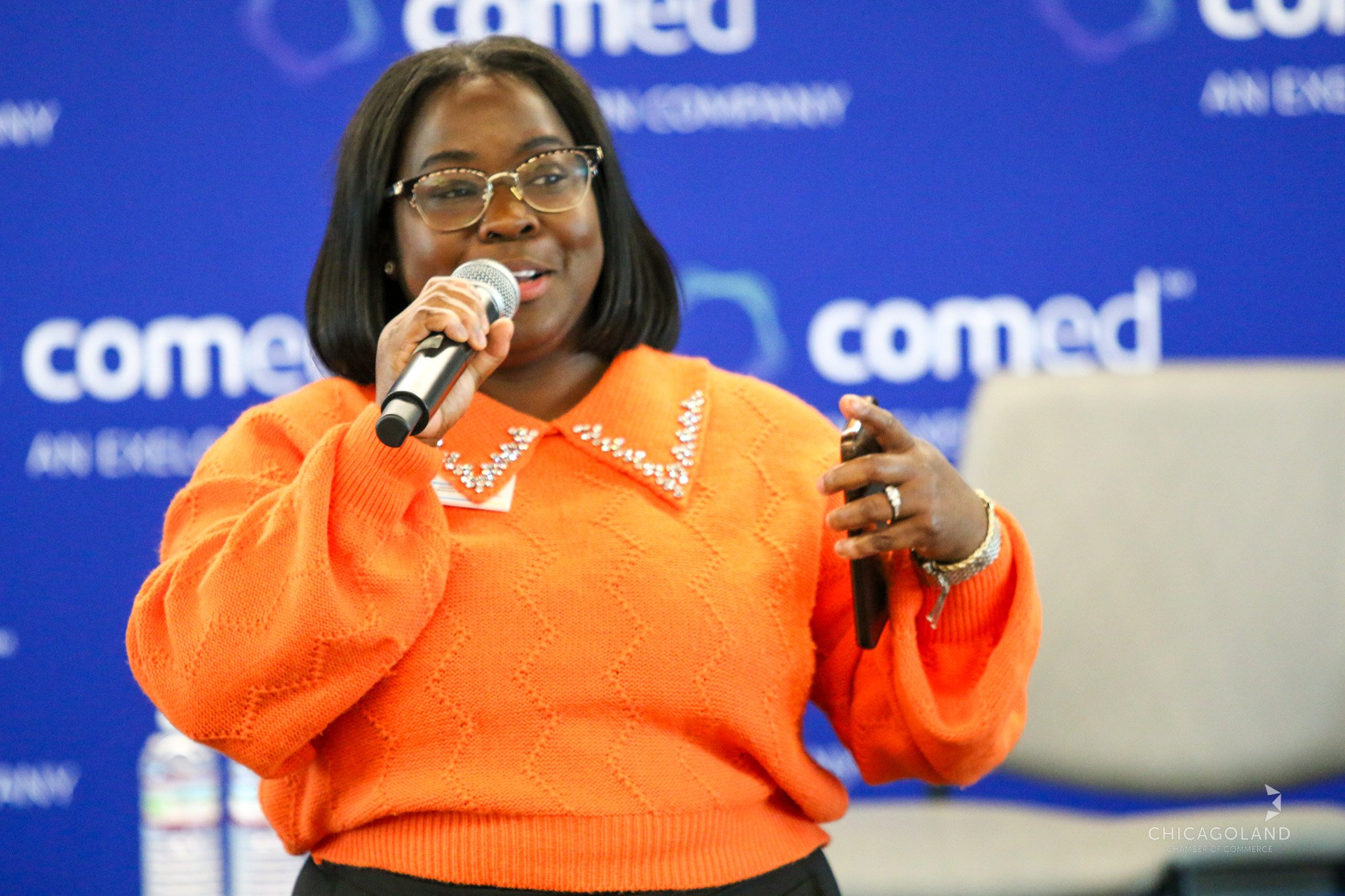Adrienne McFarland speaking with residents at a community event.